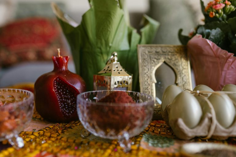 Traditional Haft-Sin arrangement with pomegranate and decorations celebrating Nowruz.